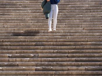 Low section of woman standing on steps