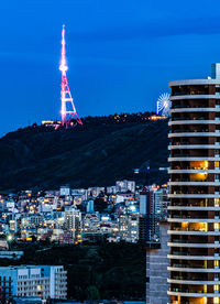 Illuminated buildings in city at night