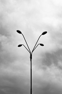 Low angle view of street light against cloudy sky