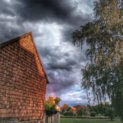 Low angle view of building against cloudy sky