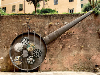 Close-up of metal hanging against wall in building