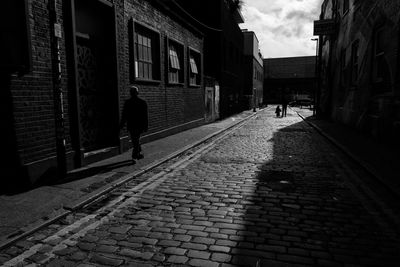 People walking on road amidst buildings