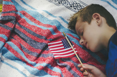 High angle view of boy sleeping on bed