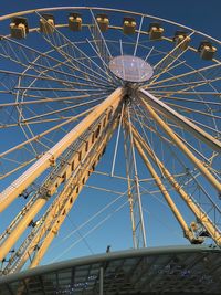 Low angle view of ferris wheel against sky