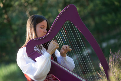 Young woman playing harp