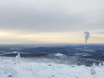 Scenic view of snow covered landscape against sky