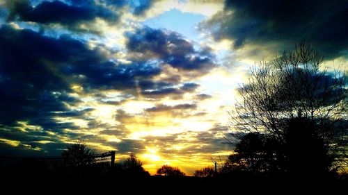 Silhouette trees against sky during sunset