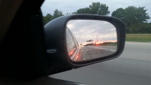 Reflection of car on side-view mirror