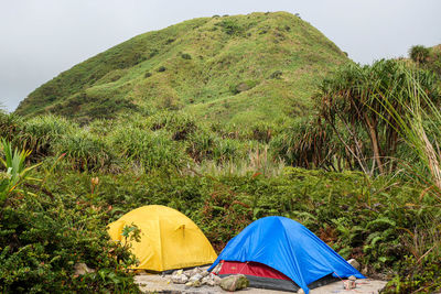 Scenic view of tent on mountain against sky