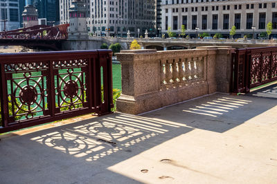 Shadow of railing on sidewalk in city
