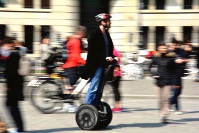 Blurred motion of people walking on road