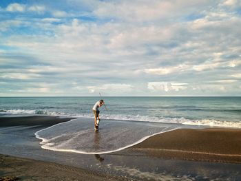 Full length of man on beach against sky