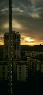 Buildings in city against sky during sunset