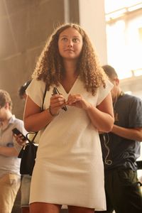 Young woman with arms raised standing in hair