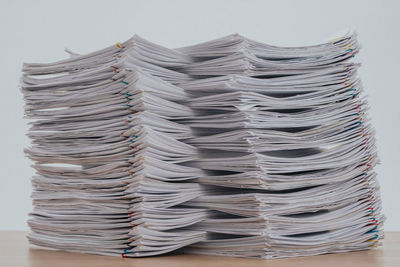 Close-up of stack on table against white background