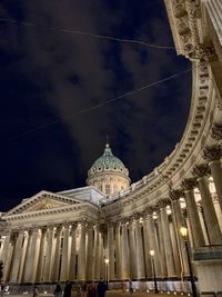 Low angle view of illuminated building against sky in city