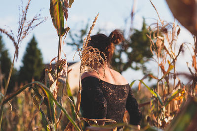 Rear view of woman on plants