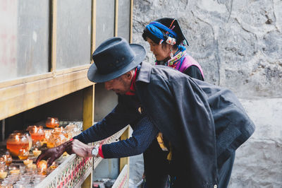 Side view of a man holding food