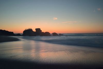 Scenic view of calm sea at sunset