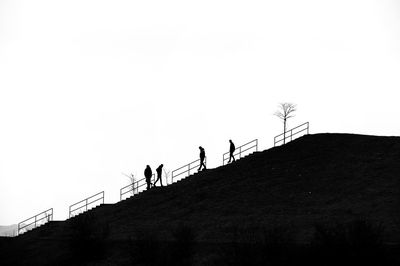 Low angle view of people against clear sky