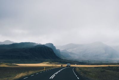 Car on country road against mountains