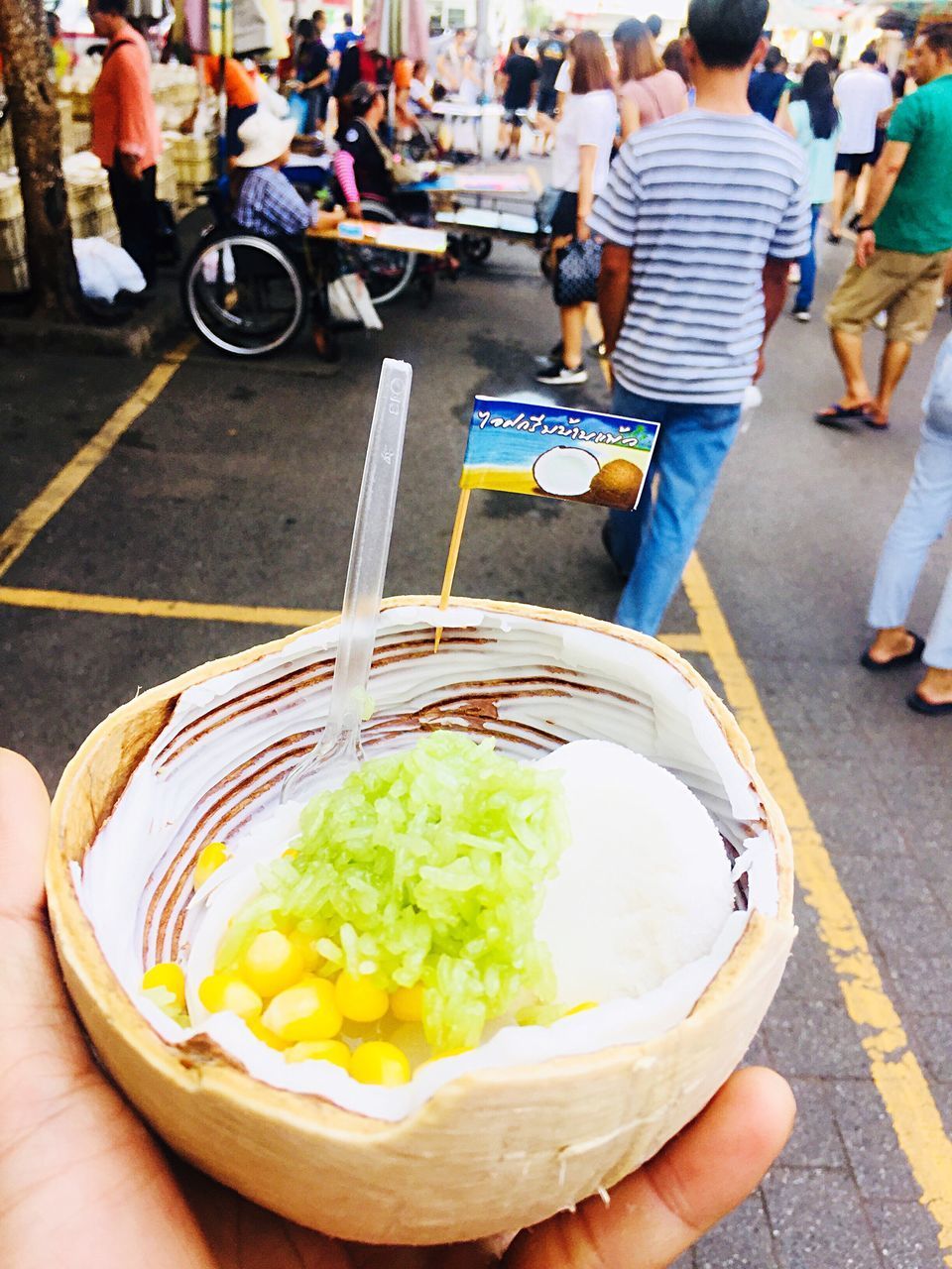 PEOPLE HOLDING ICE CREAM ON STREET