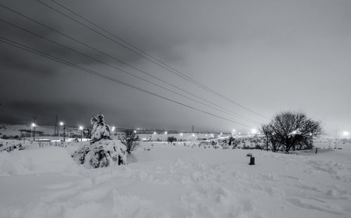 Scenic view of snow covered field against sky