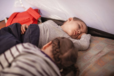 High angle view of baby sleeping on bed at home