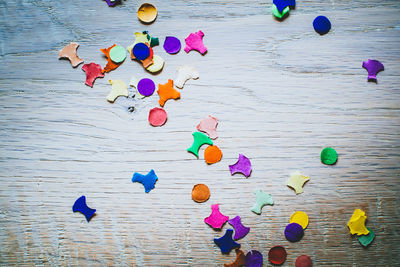 Directly above view of scattered colorful papers on table