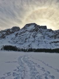 Scenic view of snow covered mountains against sky