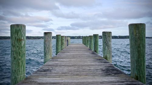 Pier over sea against sky