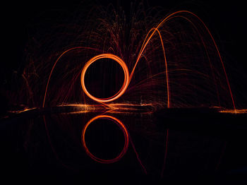 Illuminated wire wool at lakeshore