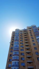 Low angle view of buildings against clear blue sky