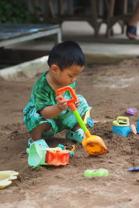 Portrait of boy playing with toys