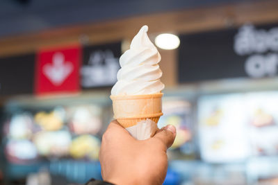 Close-up of hand holding ice cream cone
