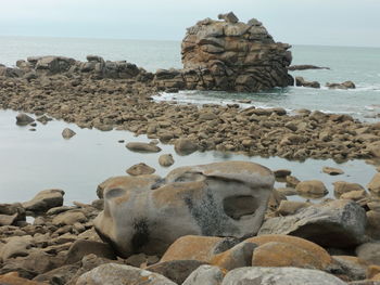 Rocks on beach against sky