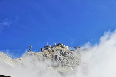 Scenic view of mountains against cloudy sky