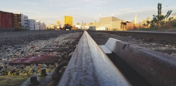 Surface level of railroad tracks against buildings in city