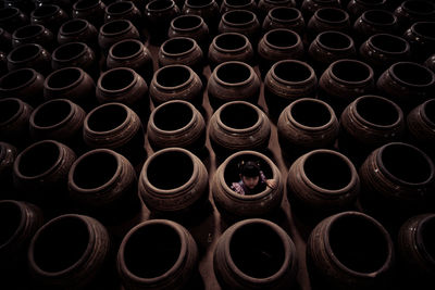 High angle portrait of girl sitting in pottery