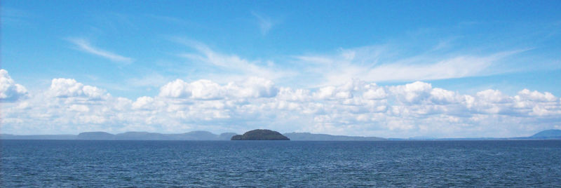 Panoramic view of sea against blue sky