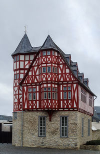 Low angle view of red building against sky