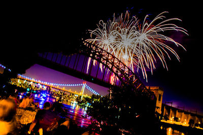 Low angle view of firework display at night