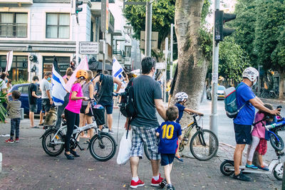 People riding bicycle on street in city