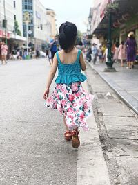 Rear view of woman walking in city