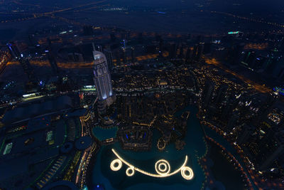 High angle view of city lit up at night