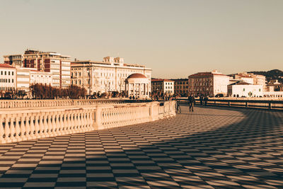 Buildings in city against clear sky