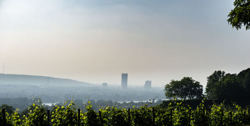 Scenic view of silhouette buildings in city against sky