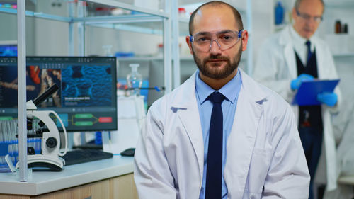 Portrait of young man standing in laboratory