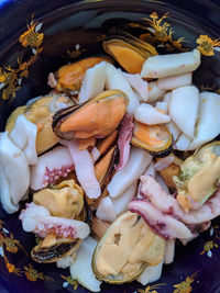 Mix of seafood in a bowl close up photo top view