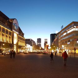 People walking in city at night